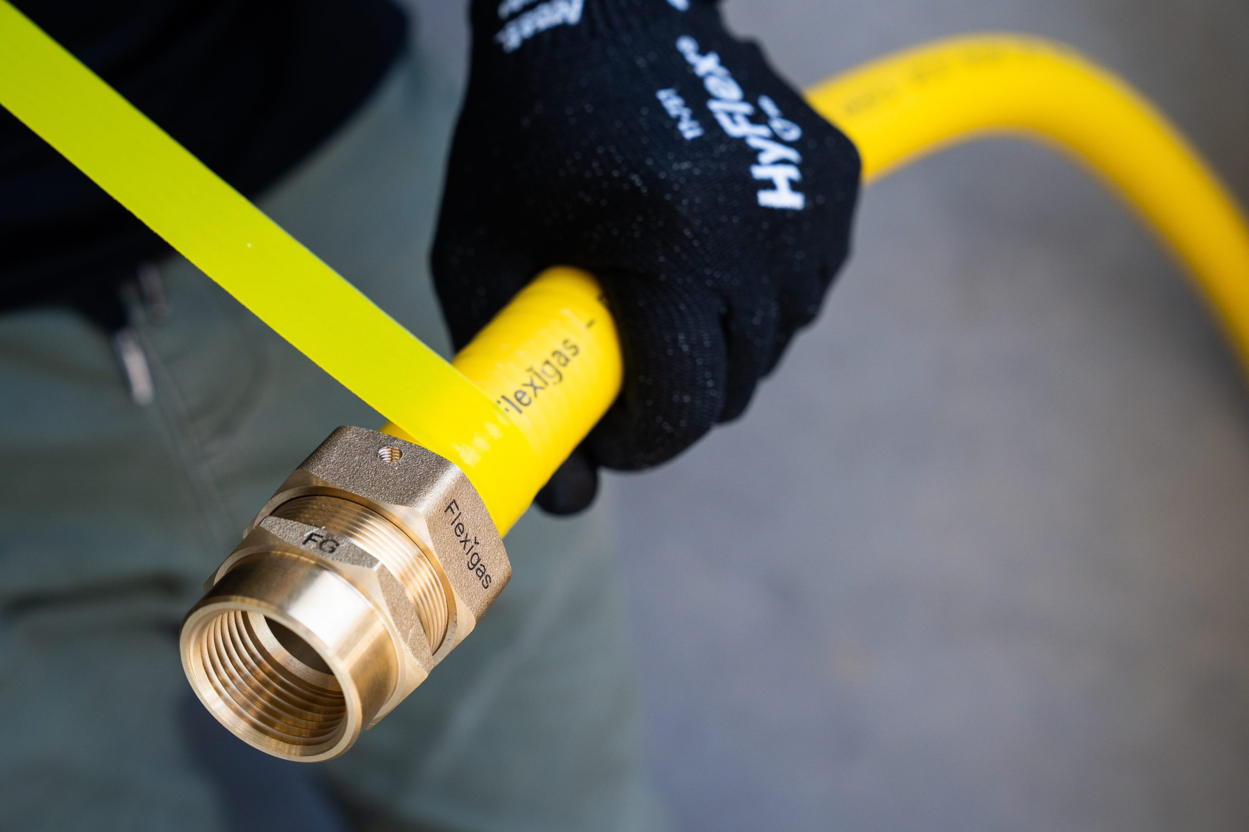 Yellow silicone tape ready to wrap the Flexigas fitting after the tightness test